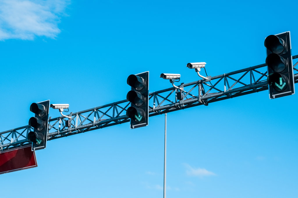 Green traffic lights and cameras against the blue sky on the highway in Istanbul, Turkey.