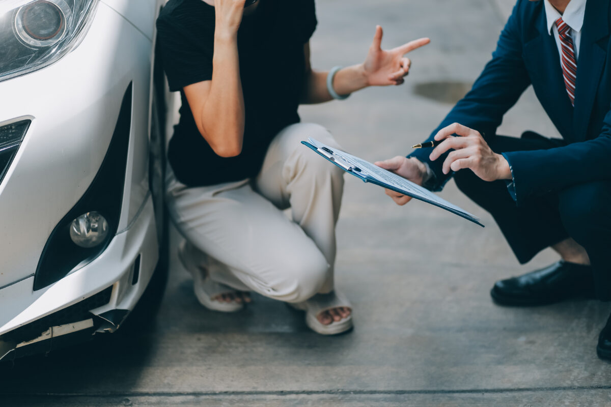 A young businesswoman is navigating car insurance options at her desk, considering premiums, deductibles, and coverage while understanding policies and managing claims efficiently.